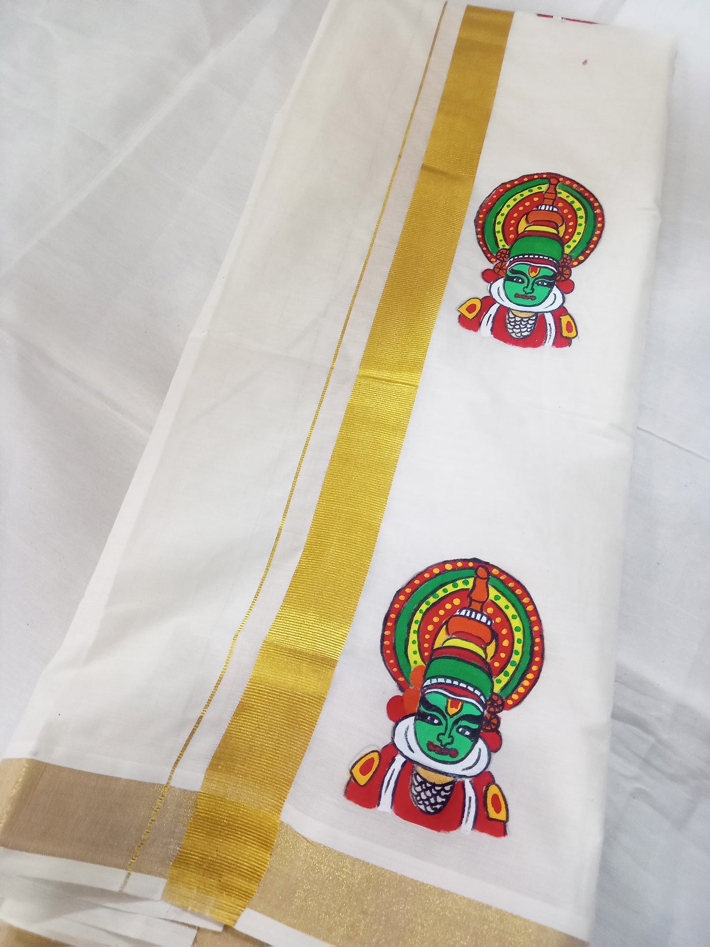 Kathakali face hand mural painting on kasavu mundu or dhoti