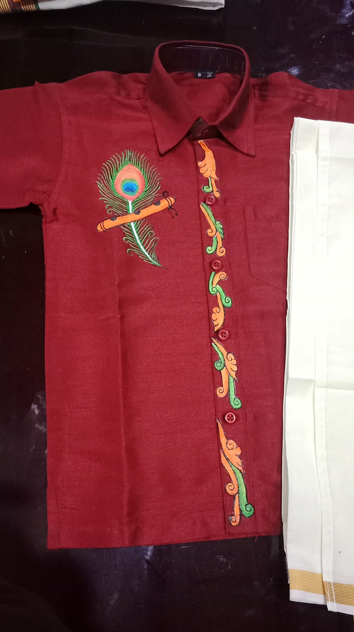 Mazhilpeeli design hand mural painting on kids red shirt and mundu
