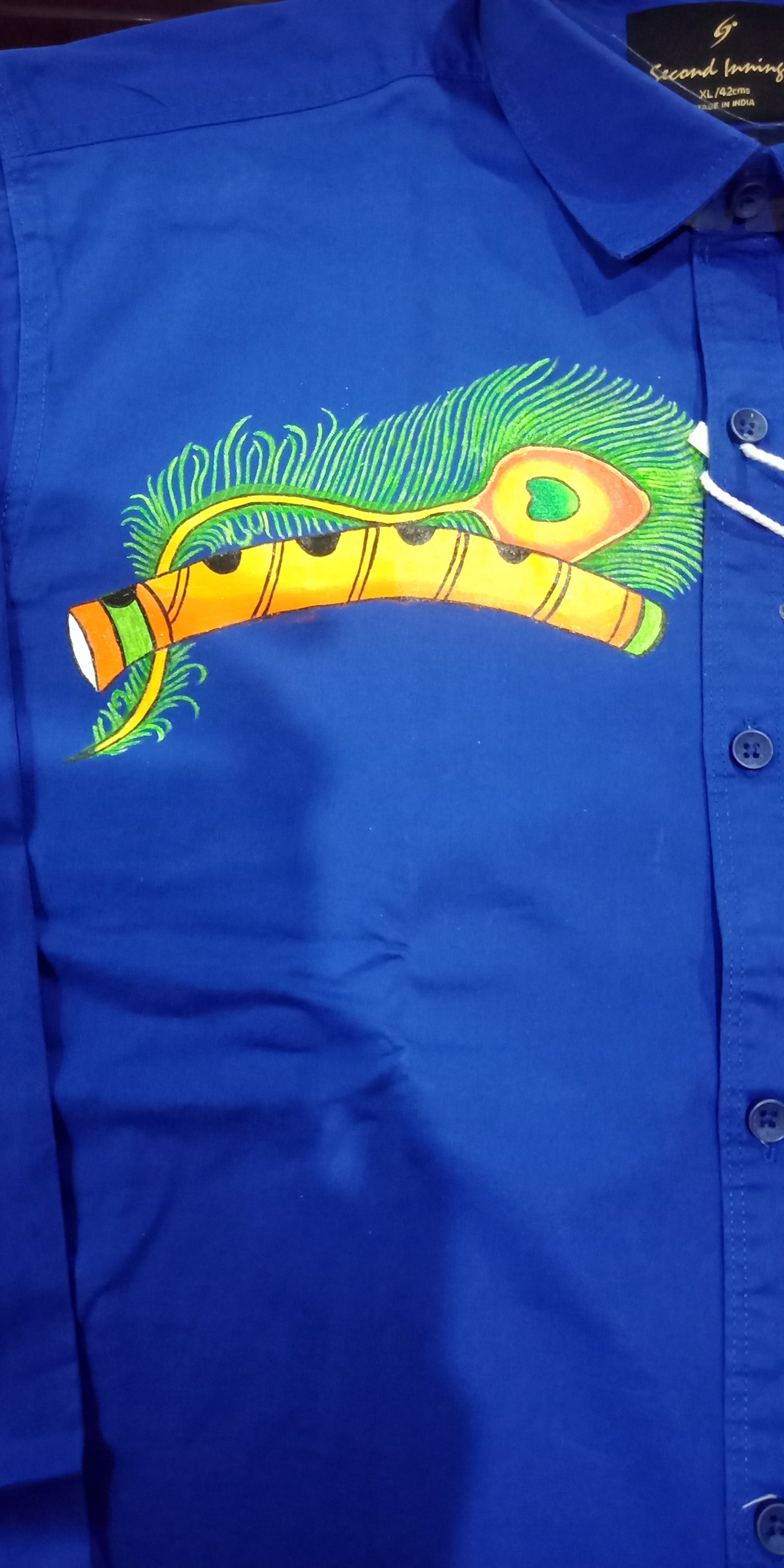 Stylish peeli with flute hand mural painting on blue cotton shirt