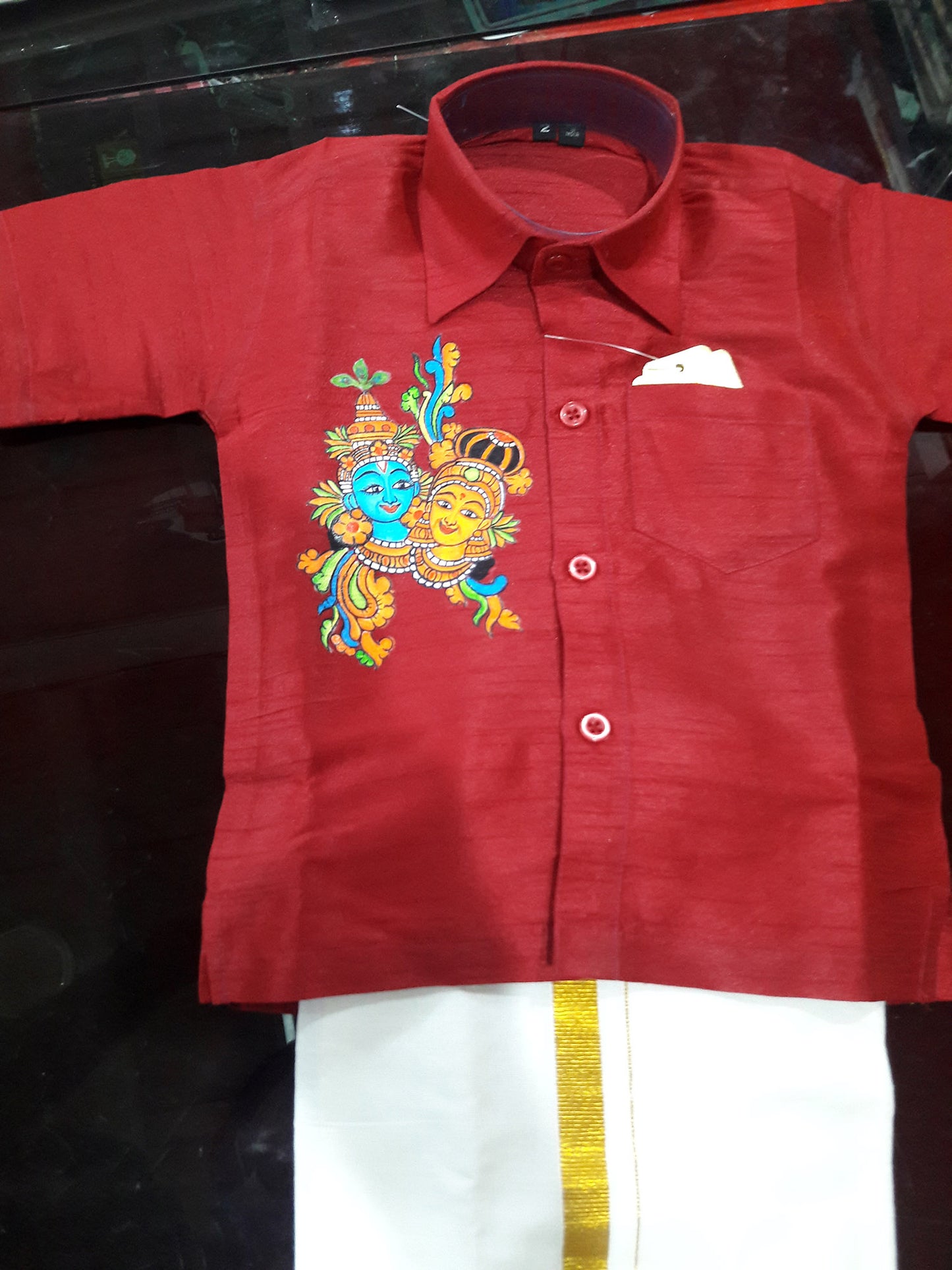 Krishna Radha hand mural painting on maroon kids shirt with mundu