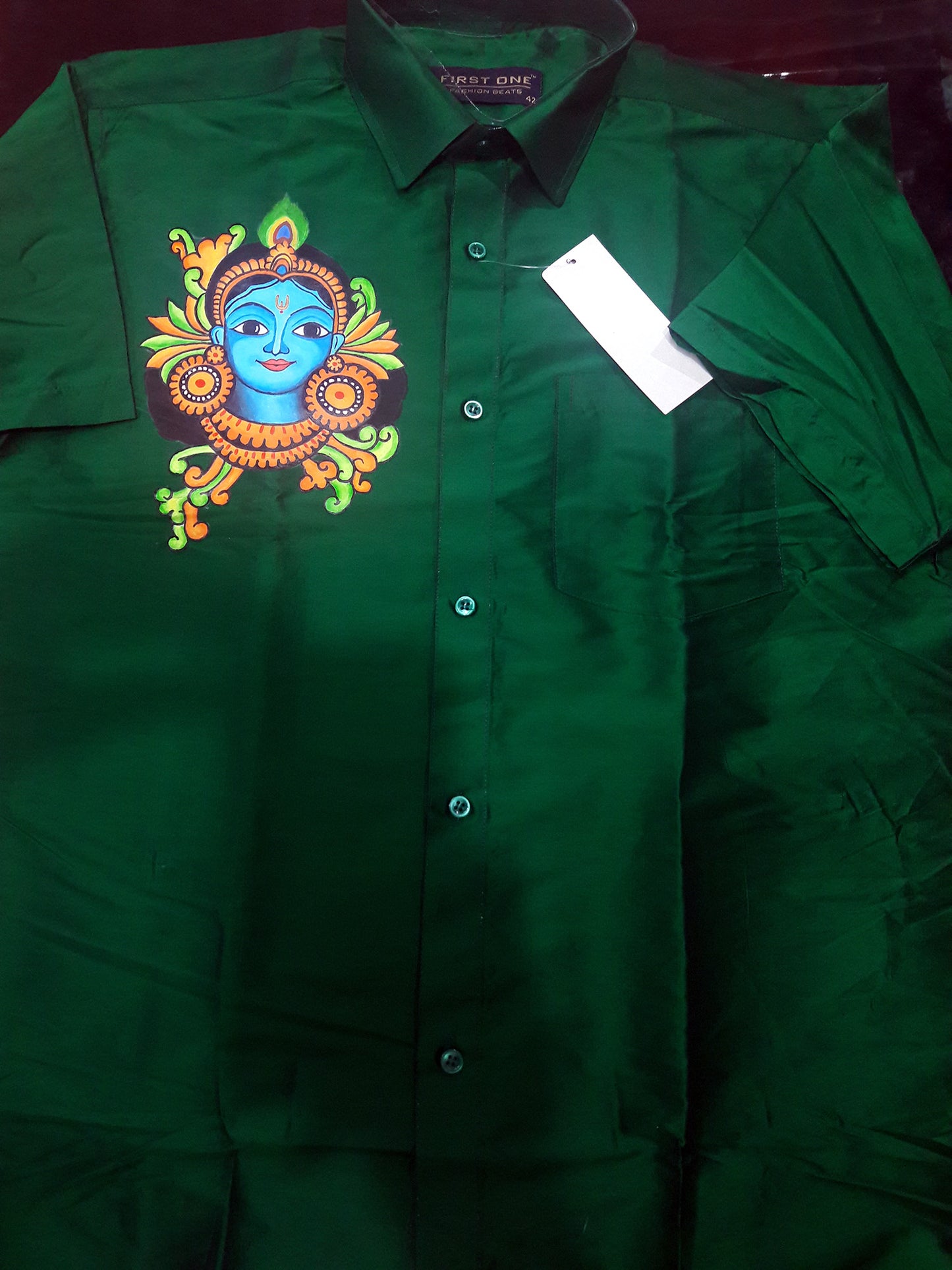 Krishna face hand mural painting on green silk shirt